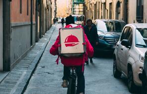 Food delivery worker riding a bicycle