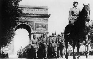 German troops parade past the Arc de Triomphe in Paris after they occupied the city in June 1940.
