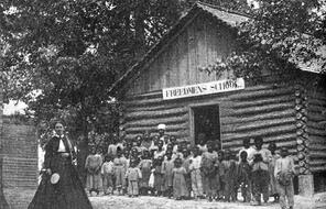 A large group of Black students standing outside a freedmen's school