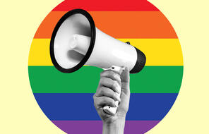 Female hand with megaphone isolated on LGBT flag background.