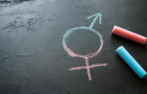 Pink and blue chalk with transgender symbol stock photo.