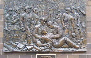 Relief depicting firefighters providing aid on 9/11.