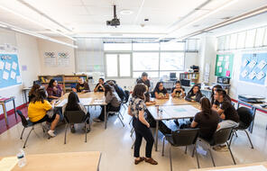 A birds eye view of a classroom filled with students in conversation.