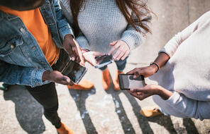 Group of young adult friends on smartphones (FH2193973)