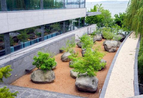 Organic sculptural memorial of rocks with trees in them
