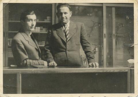 Moses Ferber and his Business Partner behind a table 