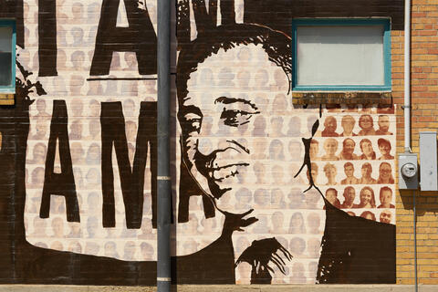 A black and white painting of Rabbi James A. Wax on the Memphis Upstanders Mural, a painting on a brick wall in Memphis, TN.
