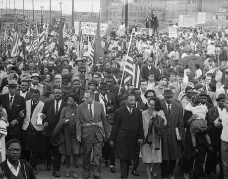 Dr. Martin Luther King leads thousands of civil rights demonstrators out on the last leg of their Selma to Montgomery 50-mile hike.