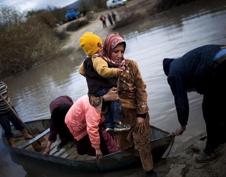 Syrian refugees cross from Syria to Turkey via the Orontes River, near the village of Hacipasa, Turkey, Dec. 8, 2012. This image was one in a series of 20 by AP photographers that won the 2013 Pulitzer Prize in Breaking News Photography.