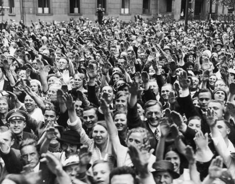 A crowd salutes Nazi Leader Adolf Hitler outside the Reich Chancellery in Berlin after a plebiscite, which gave Hitler absolute power as German Fuhrer. August 19, 1934.