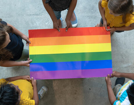 Students hold a pride flag